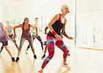 Energetic fitness instructor leading aerobics class