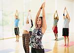 Yoga class with arms raised