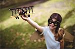 Girl playing with a toy aeroplane