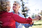 Happy senior couple dancing in the park