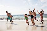 Happy family running on beach