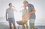 Cute group of friends having a barbecue and beers