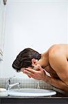 Man washing his face in the bathroom