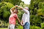 Senior coupe dancing in yard