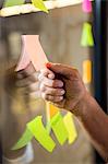 Man holding sticky notes on window