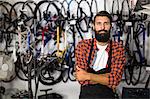 Bike mechanic standing with arms crossed