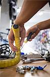 Close-up of worker repairing bicycles