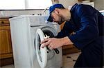 Handyman repairing a washing machine