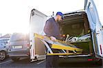 Handyman loading a ladder