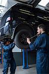 Mechanics changing car wheel