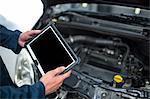 Mechanic holding diagnostic tool