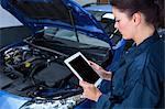 Female mechanic with digital tablet