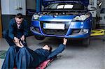 Mechanics repairing a car