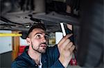 Mechanic examining car tyre