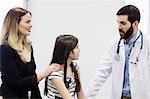 Doctor examining a sick girl