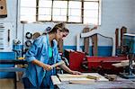 Female carpenter using a hammer