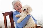 Senior woman holding a dog