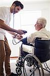 Nurse measuring the blood pressure of a senior man