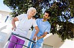 Nurse helping senior woman to walk