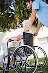 Nurse pushing the senior womans wheelchair