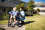 Nurse pushing the senior womans wheelchair