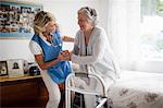 Nurse posing with a senior woman