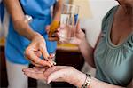 Nurse giving medicaments to a senior woman