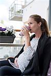 Pregnant woman relaxing on balcony