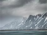 Storm clouds over mountains and lake