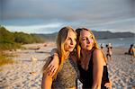 Teenage girls on beach at sunset