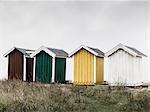 Wooden huts against overcast sky