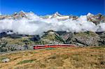 The Bahn train on its route with high peaks and mountain range in the background, Gornergrat, Canton of Valais, Swiss Alps, Switzerland, Europe