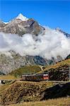 The red Bahn train proceeds with the peak of Dent Herens in the background, Gornergrat, Canton of Valais, Swiss Alps, Switzerland, Europe