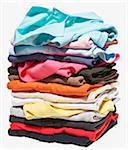 Stack of different coloured polo shirts on white background