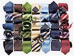 Group of multi coloured neckties roled-up on white background