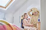 Girls playing with wig in loft room