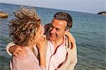 Happy mature couple strolling at seaside, Majorca, Spain