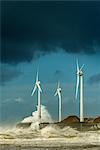 Three wind turbines amidst fierce storm waves at coast, Boulogne-sur-Mer, Nord-pas-de-Calais, France