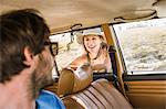 Man chatting up woman at car window on coast road, Cape Town, South Africa