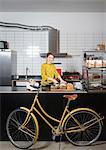 Portrait of waitress slicing bread at hipster bike repair cafe