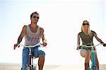 Cycling couple cycling on Venice Beach, Los Angeles, California, USA