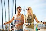 Cycling couple strolling at Venice Beach, Los Angeles, California, USA