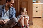 Father watching as daughter plays video game