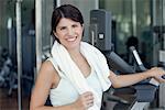 Woman smiling after workout in fitness club, portrait