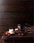 Wooden table with lit candles and glass of champagne