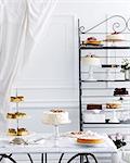 Selection of cakes on traditional tea table and stand