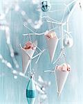 Coconut ice in paper cones hanging from painted white branch