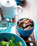 High angle view of spicy pickled mushroom in bowl with salad leaves