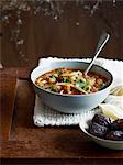 Harira soup in bowl with dates and lemon wedge