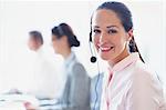 Portrait of smiling businesswoman talking on the phone with headset